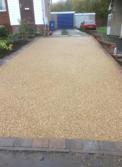 Large block paving driveway with herringbone pattern